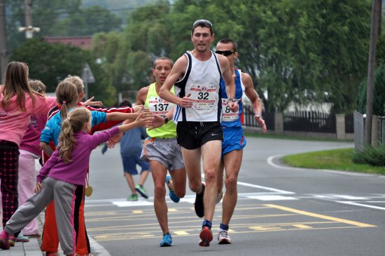 Čtyřčlenná skupinka závodníků Běhu rodným krajem Emila Zátopka, mezi nimiž je i Václav Bitala (vpravo, č. 8) z AK EZ Kopřivnice, probíhá Ženklavou a je povzbuzována místními dětmi.
FOTO: KRISTINA ČABLOVÁ